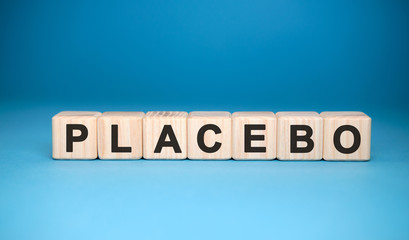 PLACEBO word cube on a blue background. Medical concept.