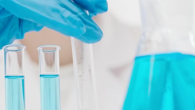 Unidentified chemist in laboratory while creating cosmetics