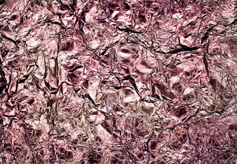 absract image of red wrinkled aluminium foil packaging