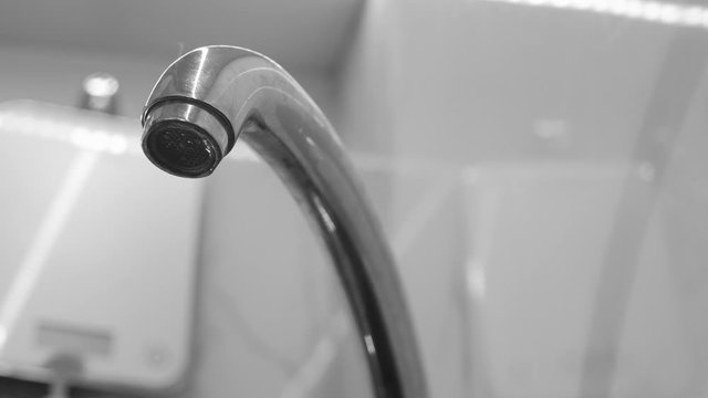 From the tap flowing water in the kitchen