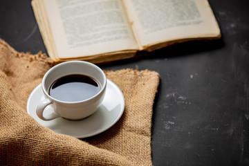 Cup of coffee and vintage book on a table