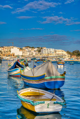 Fototapeta na wymiar Beautiful view of the traditional eyed colorful boats Luzzu, Malta.