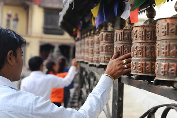 Prayer wheels in a buddhist temple in Kathmandu, Nepal - obrazy, fototapety, plakaty