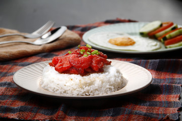 Freshly cooked Tocino or cured pork meat served with fried rice and egg with vegetables