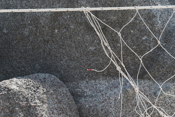 Fishing net on stone background