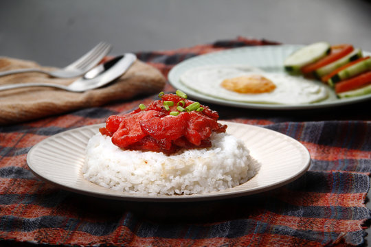 Freshly cooked Tocino or cured pork meat served with fried rice and egg with vegetables