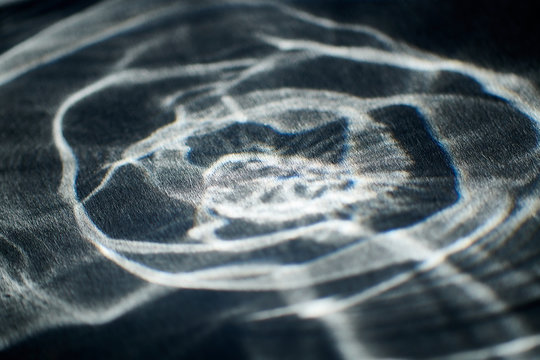 abstract light glow, lens flare, caustics water glas reflections. light through a prism. black background.