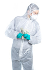 Laboratory medical worker looks suspiciously around, holding money in his hands. Bribe money. Isolated.