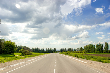 Beautiful summer landscape with clouds in blue sky in the countryside with the view from Talgar Almaty road, Kazakhstan. Road trip travel background.