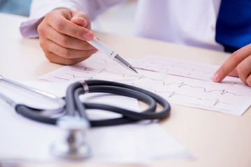 Young male doctor cardiologist working in the clinic