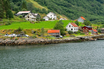Fototapeta na wymiar Rural houses in Norwegian fjords seaside landscape, Norway, Sognefjord