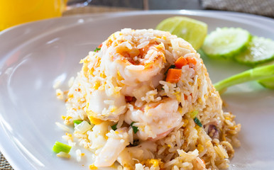 hot rice dish with vegetables and shrimp on a plate in a restaurant