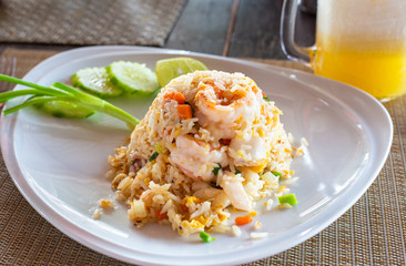 hot rice dish with vegetables and shrimp on a plate in a restaurant