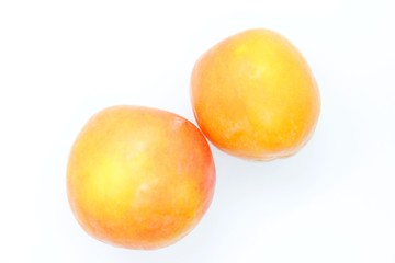 Inculate ripe plums located on a white background