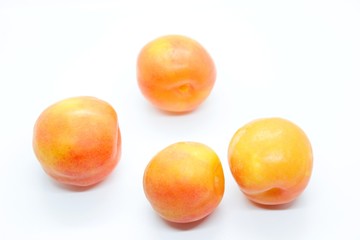 Inculate ripe plums located on a white background