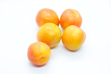 Inculate ripe plums located on a white background