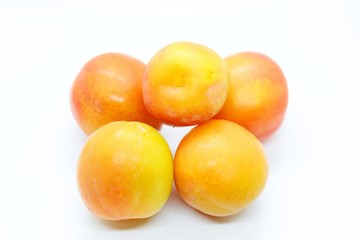 Inculate ripe plums located on a white background