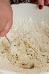 Cooking dough in a white plastic bowl at home