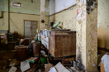 Photo of a garbage dump in an abandoned room of a destroyed factory