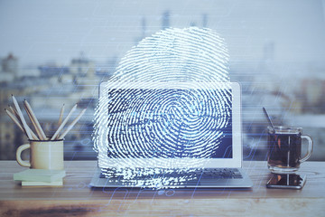 Computer on desktop in office with finger print drawing. Double exposure. Concept of business data security.