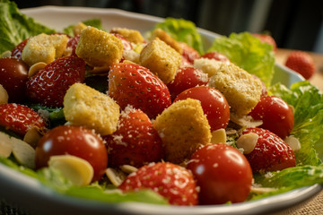 Caesar salad with strawberry close up