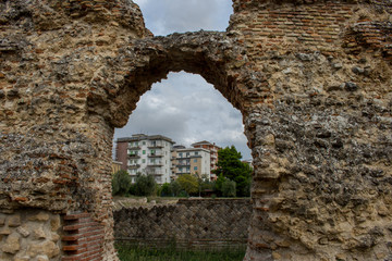 Larino, Campobasso, Roman archaeological site on the modern building background, on a sunny day