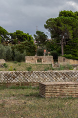 Fototapeta na wymiar Larino, Campobasso, Roman archaeological site on the modern building background, on a sunny day