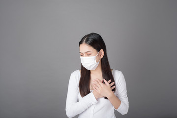 Portrait of woman with surgical mask  in studio, Health care concept