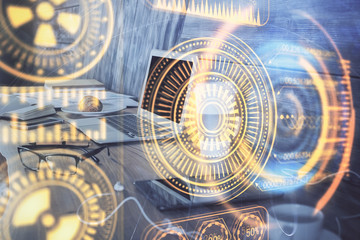 Computer on desktop in office with technology theme hologram. Multi exposure. Tech concept.