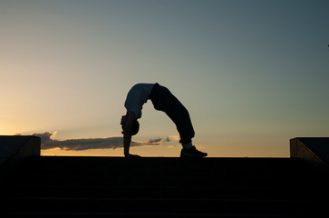 alone kung fu warrior is training against the sunset sky