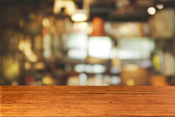 Top of empty of wood table with Blur Interior and decoration of a Modern loft coffee shop. Using for Mock up template for craft display of your design,Banner for advertise of product.