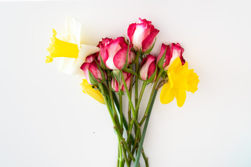 bunch of daffodils with pink roses  mock up on white background - flat lay