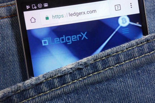 KONSKIE, POLAND - MAY 17, 2018: LedgerX website displayed on smartphone hidden in jeans pocket
