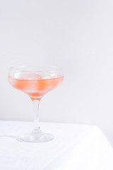 Pink cocktail with ice and mint, selective focus