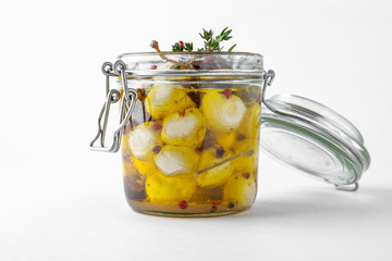 Pickled cheese with herbs, olives. Camembert, brie, mozzarella and dorblu with thyme, sage, rosemary. Gourmet Snack Delicacy. Isolated on White Background