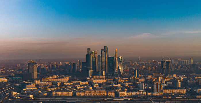 Moscow city at dawn in the orange rays of the sun aerial view.