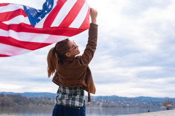 American woman holding usa flag