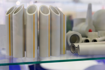 Samples of plastic water pipes on the stand. Industry