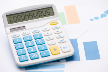 coronavirus epidemic and its financial consequences. A calculator with the word CORONAVIRUS
