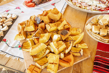Freshly baked pumpkin desert right from the oven cut in large pieces on a wooden table
