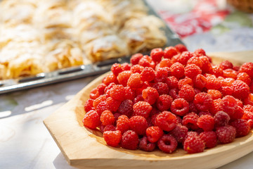 Bio raspberries on a wooden plate
