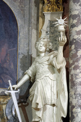 Fototapeta na wymiar Saint Barbara statue on the main altar in the Franciscan church of St. Francis Xavier in Zagreb, Croatia
