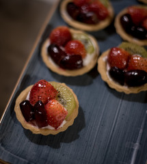 Tasty  pieces of tart cakes garnished with fresh fruits