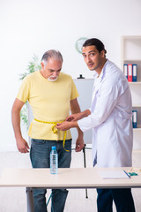 Fototapeta premium Doctor dietician giving advices to fat overweight patient