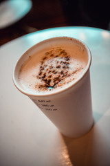 beautiful drawing of bumps on coffee. disposable glass with close-up coffee.