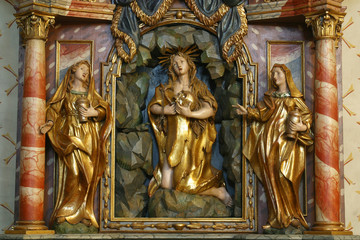 Fototapeta na wymiar The altar of Saint Mary Magdalene in the church of St. Barbara in Vrapce, Zagreb, Croatia