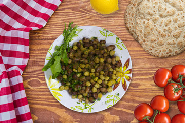foul Modammas Fava Beans and chick-peas, Top View on wood board.
