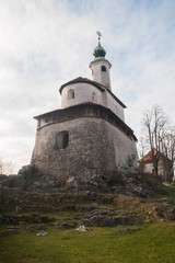 Fototapeta na wymiar Mali grad or Small castle in Kamnik, Slovenia. One of the most famous landmarks in the old city center. Church build on top of a small hill in Kamnik.