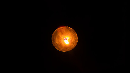 Beautiful candle in a dark room, black background