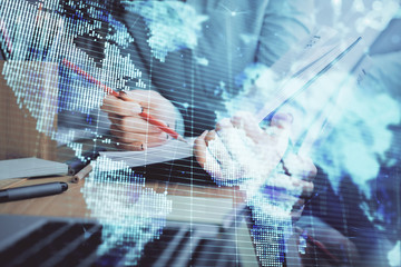 International business hologram over hands taking notes background. Concept of success. Multi exposure